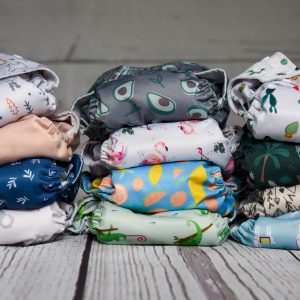 a stack of cloth diapers sitting on top of a wooden floor